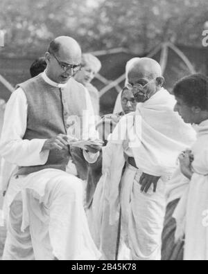 Secretary Mahadev Desai reading a letter to Mahatma Gandhi from the British Viceroy, Bombay, Mumbai, Maharashtra, India, Asia, April 1939, old vintage 1900s picture Stock Photo
