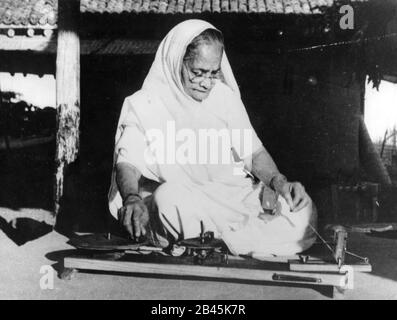 Kasturba Gandhi working on spinning wheel, Sewagram Ashram, Wardha, Nagpur, Maharashtra, India, Asia, 1940s, old vintage 1900s picture Stock Photo