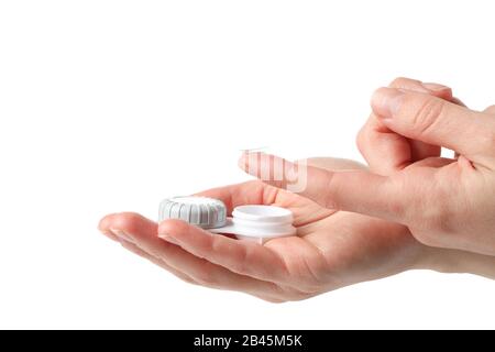 Hands with contact lens and case isolated on white background Stock Photo