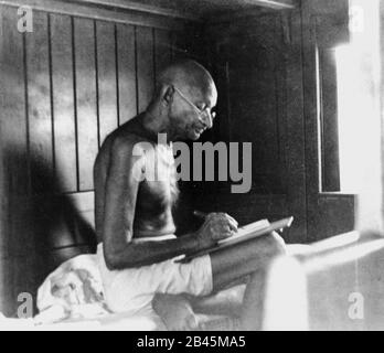 Mahatma Gandhi writing in train compartment , India, 1940s, old vintage 1900s picture Stock Photo