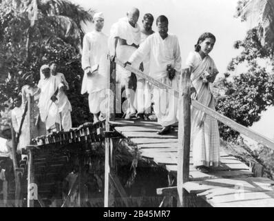 Mahatma Gandhi crossing wooden bridge on visit to West Bengal, India, Asia, November 1946, old vintage 1900s picture Stock Photo