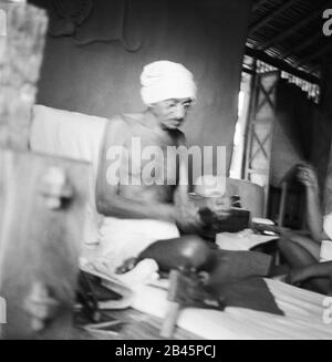 Mahatma Gandhi spinning in his hut at Sevagram Ashram, Vardha, Maharashtra, India, Asia, 1940, old vintage 1900s picture Stock Photo