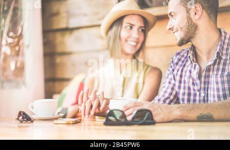 Young couple in love at cafe bar restaurant - Boyfriend and girlfriend having tender moments during summer vacation - Lover lifestyle and travel conce Stock Photo