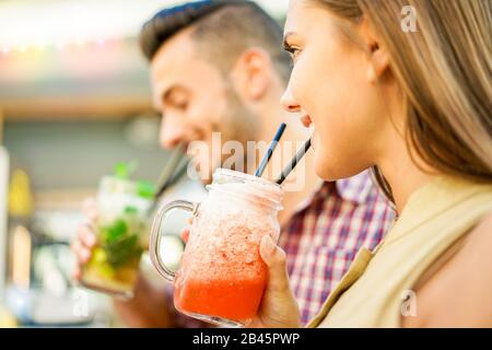 Young cheerful friends toasting cocktails in miami lounge disco bar - Young people having fun with new mixology club beverage - Party and happy hour c Stock Photo