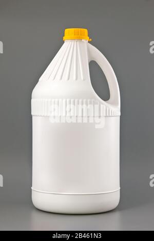 White detergent plastic bottle isolated on gray. Stock Photo