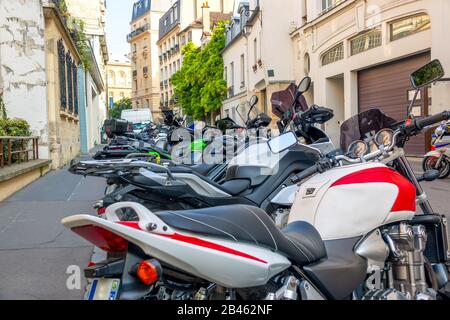 France, Paris. Several Motorbikes Parked on a Summer Sunny Street Stock Photo
