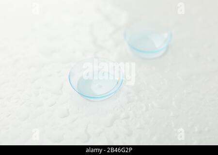 Contact lenses on white background with water, close up Stock Photo