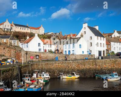 Fishing boats at the harbour at low tide in Crail East Neuk of Fife Scotland Stock Photo