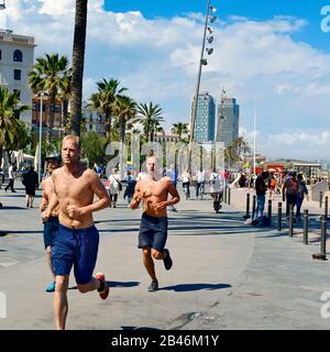 BARCELONA, SPAIN - MAY 30: People jogging and walking in the seafront of La Barceloneta on May 30, 2016 in Barcelona, Spain. The city has a long and b Stock Photo