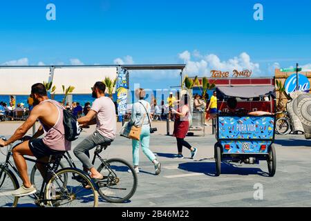 BARCELONA, SPAIN - MAY 30: People cycling and walking in the seafront of La Barceloneta on May 30, 2016 in Barcelona, Spain. The city has a long and b Stock Photo