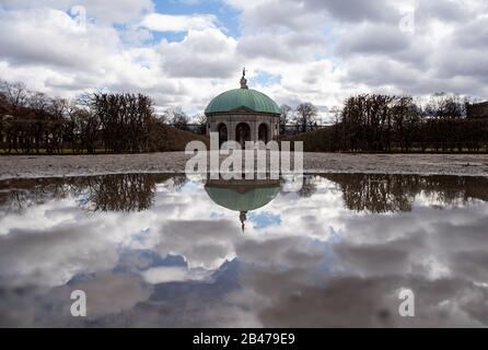 Munich, Germany. 06th Mar, 2020. The temple of Diana in the court garden is reflected in a puddle on the sidewalk. Credit: Sven Hoppe/dpa/Alamy Live News Stock Photo