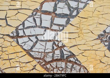 Abstract corroded old paint on metal wall. Cracked white beige yellow metal rust texture background Stock Photo