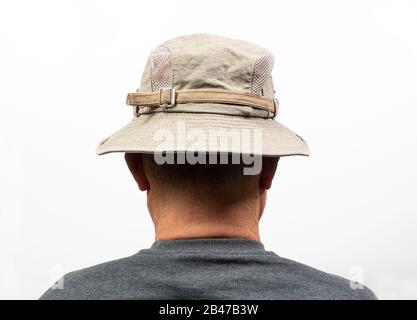 A middle-aged man turned from the back with his Hat Stock Photo