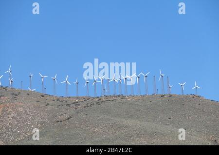 an old retro wind farm on a mountain top distance view Stock Photo