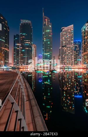 Amazing architecture parallel buildings. Cloudy night sky. Luxury travel inspiration. Dubai Jumeirah Lake Towers. Stock Photo