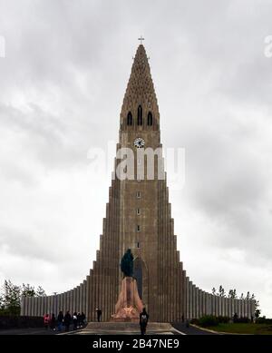 Europe ,Iceland , Statue of Leif Erikson, historic explorer front of the futuristic spire and concrete columns of Hallgrimskirkja, the iconic Lutheran church in Reykjavik Stock Photo
