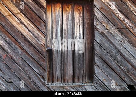 a wood timber pioneer homestead farm barn shutter window close-up Stock Photo