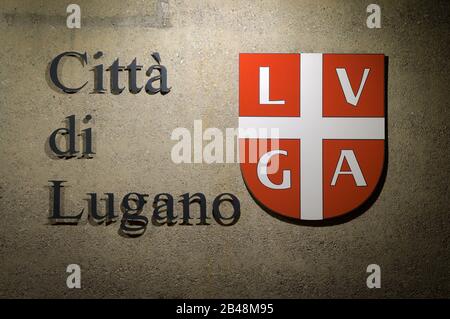 Lugano, Ticino, Switzerland - 25th July 2019 : Illuminated official emblem and script of the City of Lugano. Lugano is one of the most touristic Swiss Stock Photo