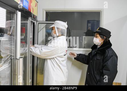 Wuhan, China's Hubei Province. 6th Mar, 2020. A staff member reserves a meal as sample for later examination at a catering company in Wuhan, central China's Hubei Province, March 6, 2020. Credit: Cheng Min/Xinhua/Alamy Live News Stock Photo