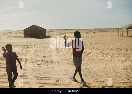 Nouadhibou, Mauritania, JANUARY 18, 2020: Unidentified boys waves his hand in the village next to road. Stock Photo