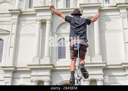 Street Performer on Unicycle in Front of St. Louis Cathedral in New Orleans, Louisiana Stock Photo