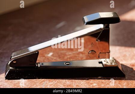 stapler from the side in bright sunlight at the office Stock Photo
