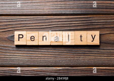 PENALTY word written on wood block. PENALTY text on wooden table for your desing, concept. Stock Photo