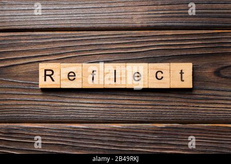 Reflect word written on wood block. Reflect text on table, concept. Stock Photo