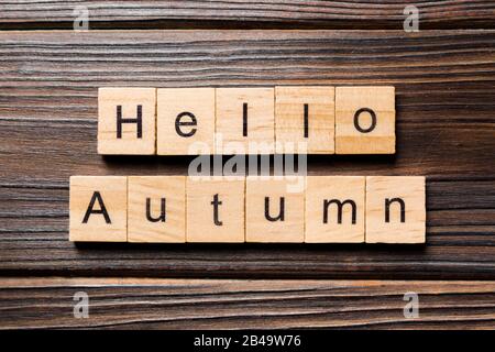 Hello autumn word written on wood block. autumn text on wooden table for your desing, concept. Stock Photo