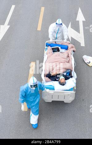 Wuhan, China's Hubei Province. 6th Mar, 2020. In this aerial photo, medical workers transport a COVID-19 patient to the CT room at a hospital affiliated to the Tongji Hospital in Wuhan, capital of central China's Hubei Province, March 6, 2020. Medical workers have been racing against time on the frontline of the fight against the novel coronavirus epidemic in Wuhan. Credit: Cai Yang/Xinhua/Alamy Live News Stock Photo
