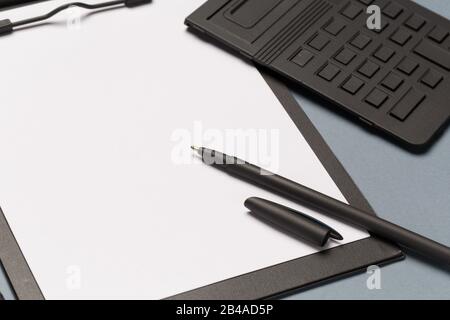 Notes clipboard with pen, calculator and blank sheets of paper as mock up copy space, top view Stock Photo