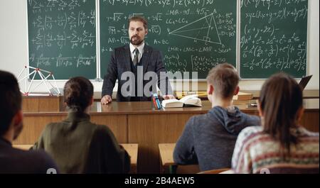 Teacher with students in classroom Stock Photo