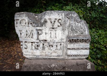 Broken marble stone with latin inscription on display at the Forum, Rome Stock Photo