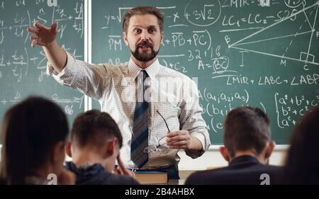 Enthusiastic mathematician explaining subject Stock Photo