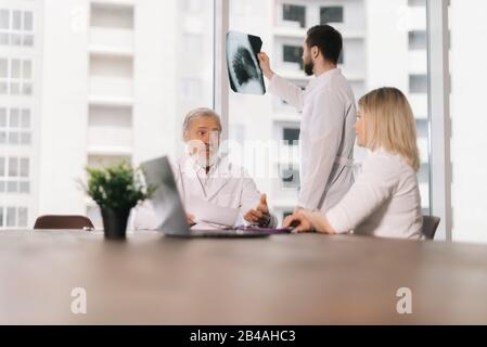 Young doctor stands by the window with an X-ray Stock Photo