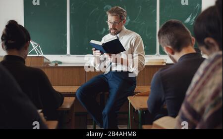 Students listening to teacher's reading Stock Photo