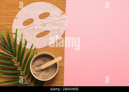 Natural skin care products at home. Gray clay in a bowl mask cloth sponge from natural environmentally friendly material on a pink background with gre Stock Photo