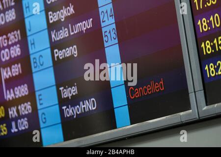 Hong Kong, China. 06th Mar, 2020. A view of a cancelled flight sign on the flight schedule information board at Hong Kong International Airport.As the Coronavirus (Covid-19) continues to spread all over the world, many countries have tighten up travel restrictions. Credit: SOPA Images Limited/Alamy Live News Stock Photo