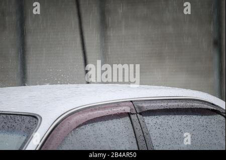Rain droplet on the roof car in rainy season Stock Photo