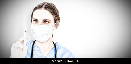 Young brunette woman doctor holding an injection . Testing for Coronavirus pandemic Stock Photo