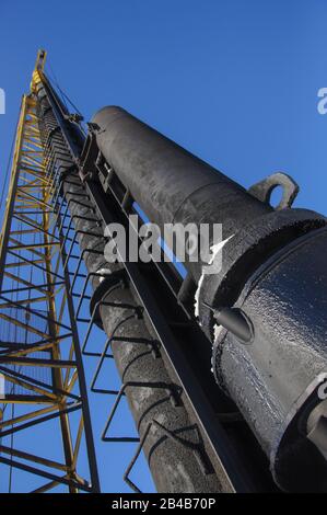 Diesel hammer machine for installing concrete piles for the foundation of a new building Stock Photo