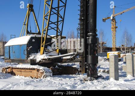 Diesel hammer machine for installing concrete piles for the foundation of a new building Stock Photo