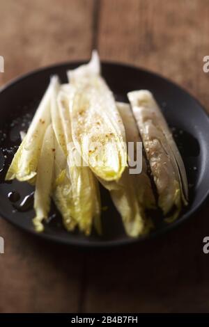 Melted cheese, endive salad for bacon potato Stock Photo