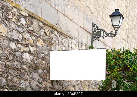 Mock up. White blank signboard advertising board, information board on old stone wall in european city Stock Photo