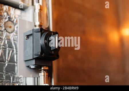 The handle of the Black industrial automatic machine is round, the scroll wheel is in the factory. Free space Stock Photo