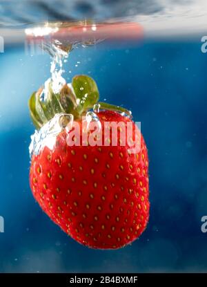Strawbery dropped in to deep water Stock Photo