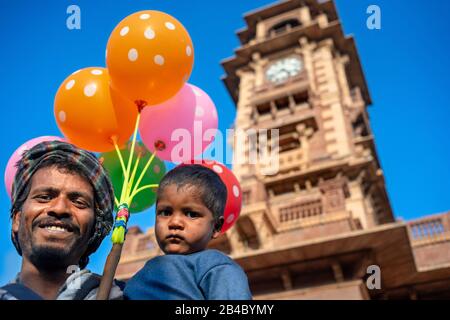 Baloon seller in the Clock Tower and Sardar Market square in Jodhpur city Rajasthan India. This is one of the excursion of the Luxury train Maharajas Stock Photo