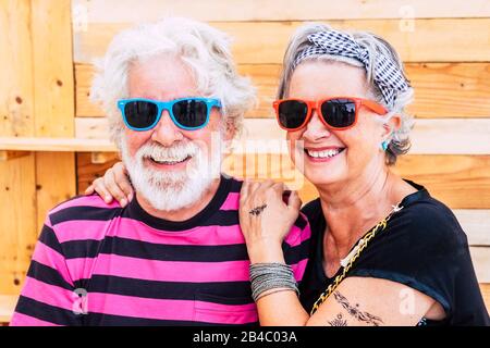 Nice and young senior active couple together in love and friendship in front of the camera - no limit age for modern retired lifestyle people - cheerful old man and woman smile and have fun Stock Photo