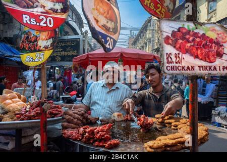 Food stall street in the Crawford Market Mumbai India. Hectic Crawford Market (officially renamed Mahatma Jyotiba Phule Mandai) is an old-style market Stock Photo