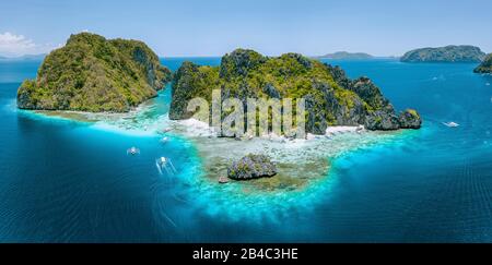 Aerial drone view of tropical Shimizu Island steep rocks and white sand beach in blue water El Nido, Palawan, Philippines. Tourist attraction most beautiful famous nature spot Marine Reserve Park. Stock Photo